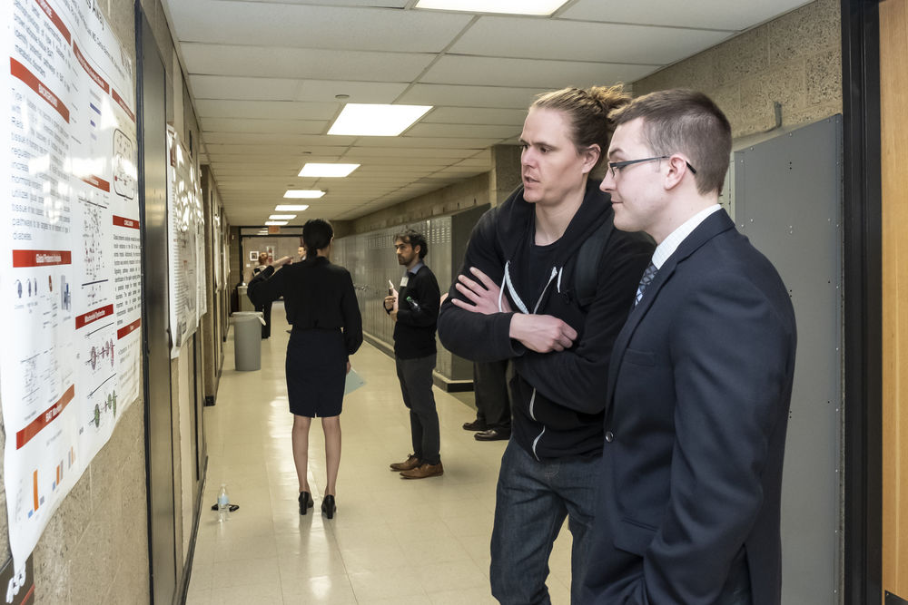 Two pharmacy students discussing a research poster on Research Day